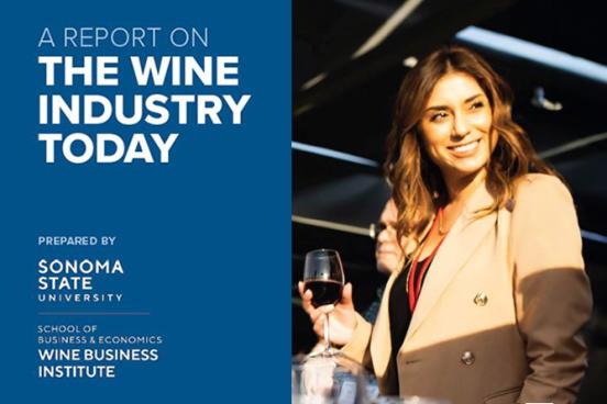 A lady holding a wine glass and smiling at a wine tasting event