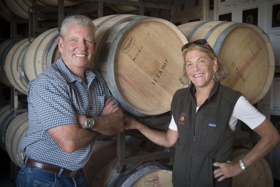 Rand and Debbie Lewis standing in barrel room