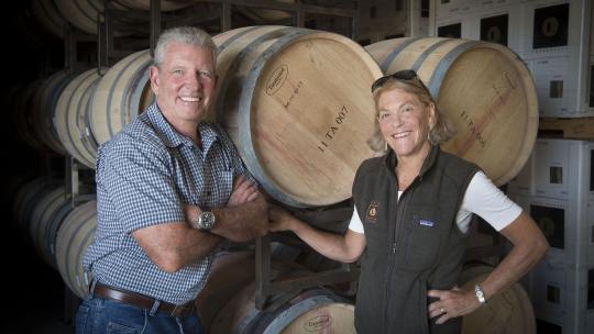 Rand and Debbie Lewis standing in barrel room