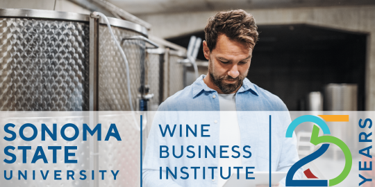 man in beverage production room with stainless steel tanks logo wine business institute